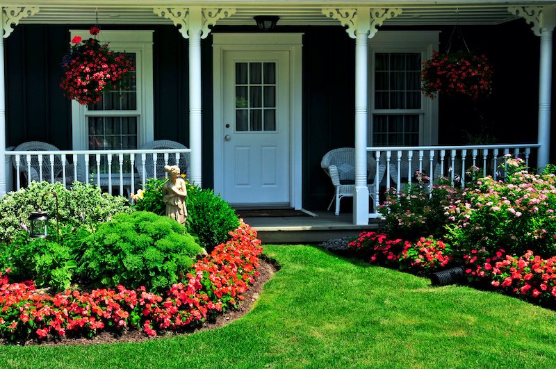 July Landscaped front yard of a house with flowers and green lawn