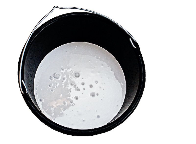 bucket of gray paint on white background