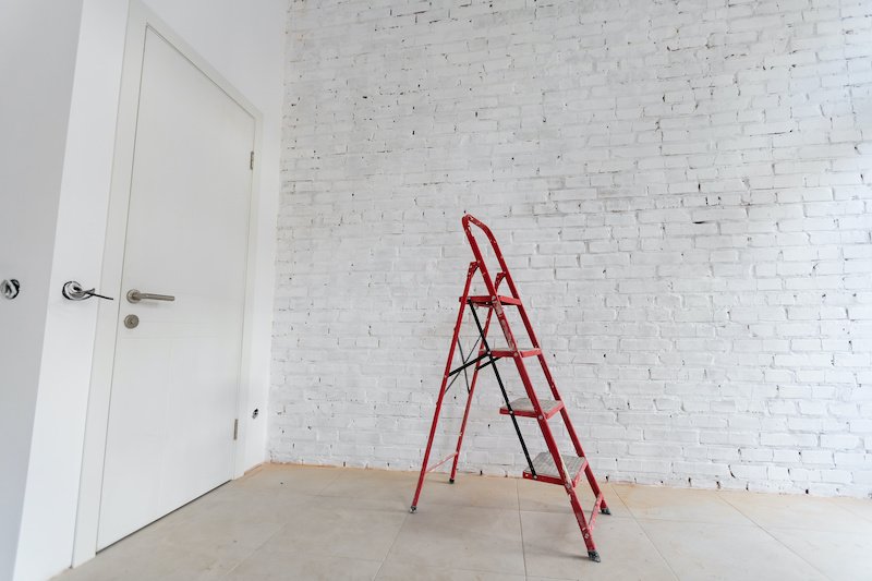 White staircase on a white background with a copy of the space. Minimal style. The concept of motivation, construction and repair