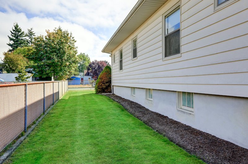 House exterior. View of side wall and green grass. Northwest, USA