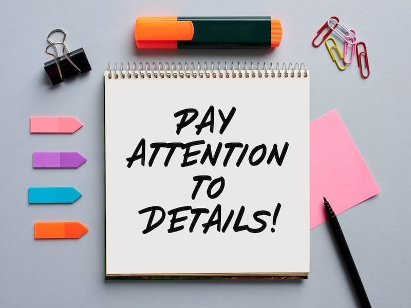 The message pay attention to details written on a notebook on business office desktop.