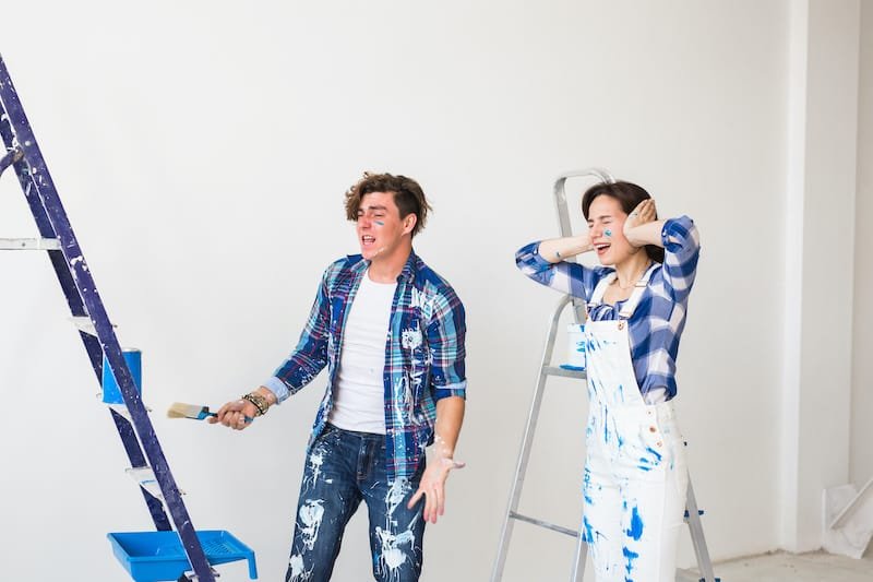 Conflict, redecoration and renovation concept - Young woman and man with annoying faces and bad emotions during renovation in apartment.