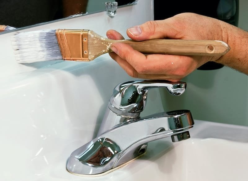 worker painting a bathroom wall with white paint bathroom paint