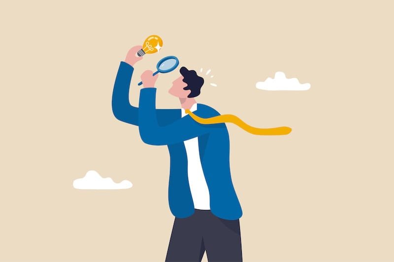 Perfectionist, too much attention to details, high standard goal, focus on perfect result concept, perfectionist businessman with magnifying glass looking at every details of lightbulb idea.