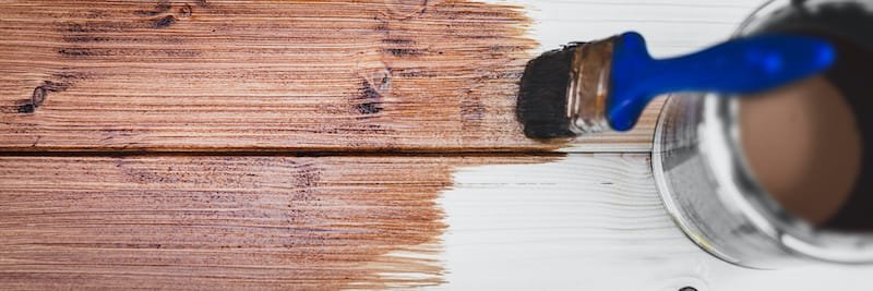 panorama of a wooden board with a brush and brown glaze, close up