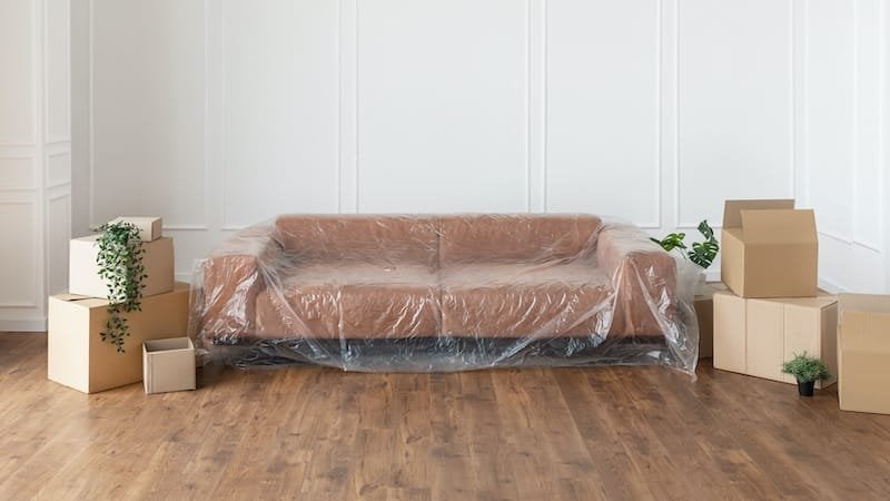 Cover couch and move things for paint prep