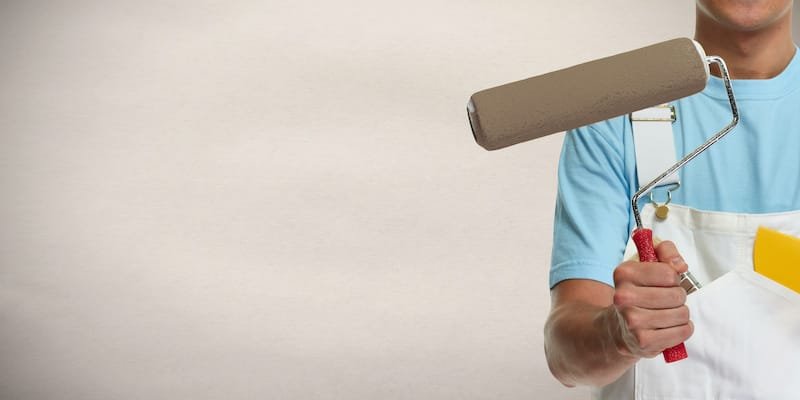 man painter hand with painting roller. House renovation