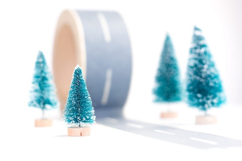 Construction of new asphalt road. Scotch tape with painted asphalt and trees on white background Christmas House Painting