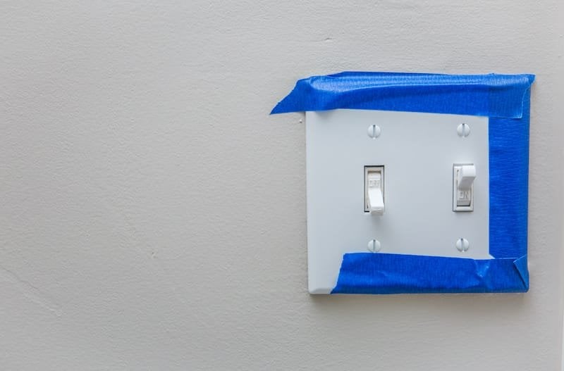 Light switch with blue painter's tape around it
