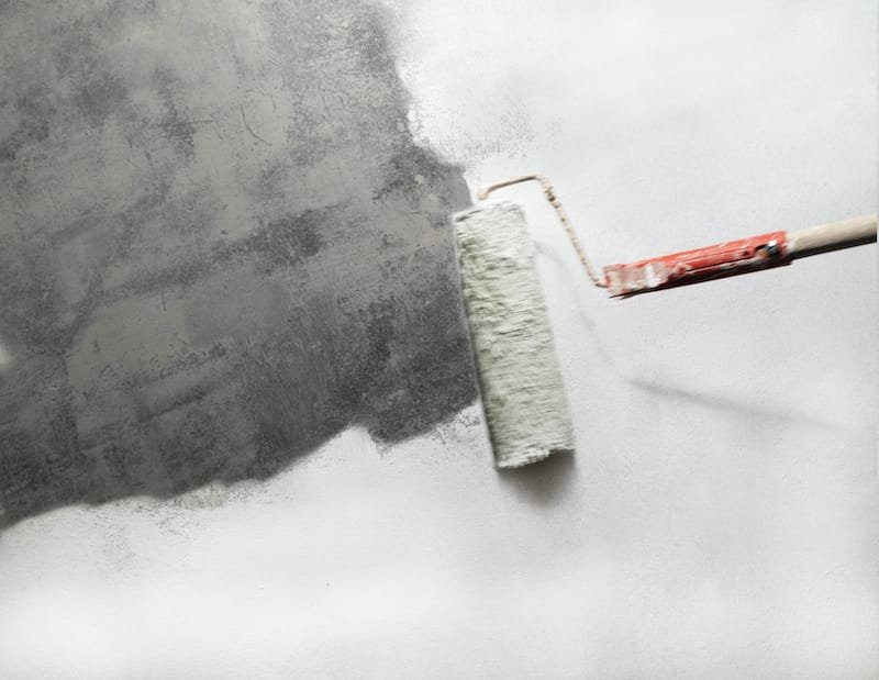 unpainted part concrete with paint roller