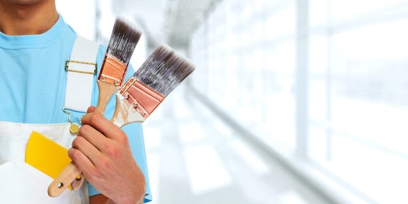 Professional man painter hand with brush. House renovation