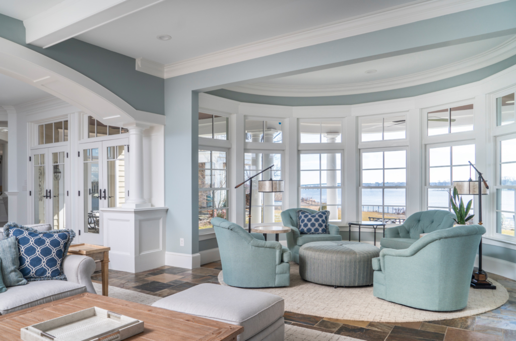 Bright coastal-style living room with soft blue walls and white trim by a house painter in Middleton, ID