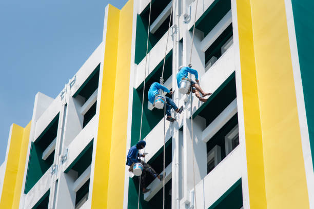 Commercial building exterior repainting with white, yellow, and green finishes by a painting company in Eagle, ID