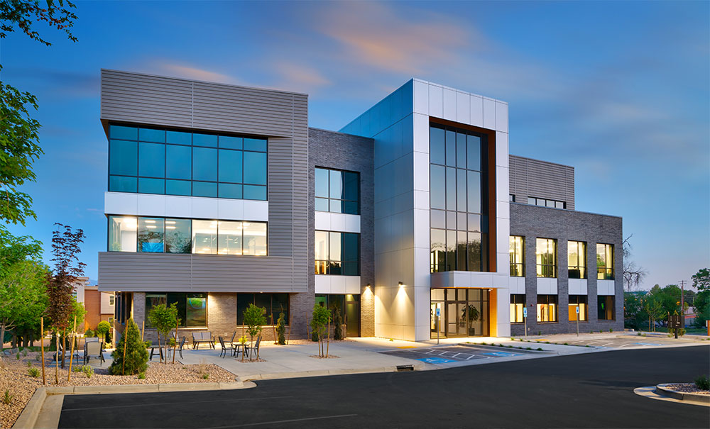 Office building painted in silver with white accents applied by a commercial painter in Meridian, ID