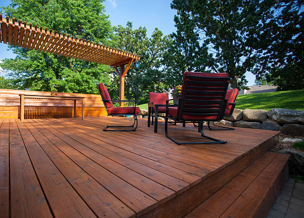Stained wooden deck with outdoor seating showcasing services from a painting company in Middleton, ID.