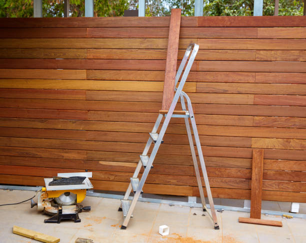 Professional fence staining project with wood fence and tools, highlighting a painting company in Middleton, ID.